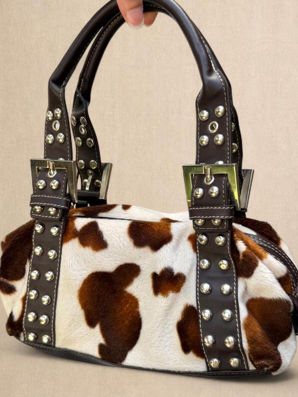 Y2K cow print mini handbag with silver studs and buckle strap